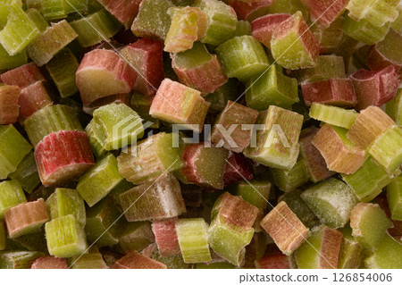 Freshly peeled chopped rhubarb stalks ready for culinary adventures in kitchen. Frozen food. Save for cooking later. Food pattern. Freshly peeled chopped rhubarb stalks ready for culinary adventures in kitchen. Frozen food. Save for cooking later. Food pattern. 126854006