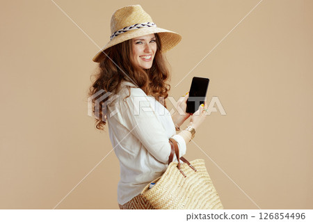 happy trendy woman showing smartphone blank screen happy trendy woman showing smartphone blank screen 126854496