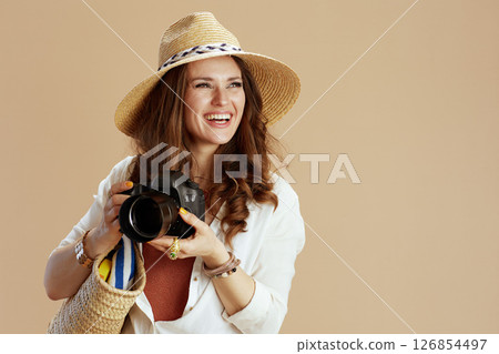 smiling elegant woman in blouse and shorts isolated on beige 126854497
