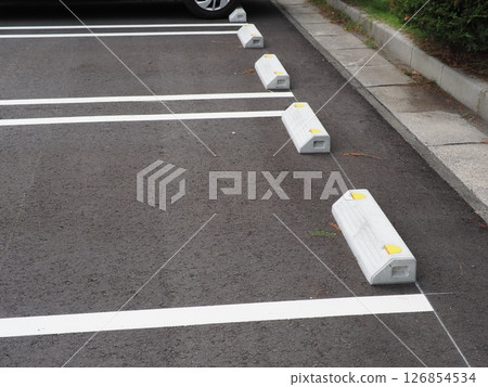 A scene from a parking lot. Copy space. Search for and feel the world hidden in the asphalt. Enjoy the time on a cloudy day. 126854534