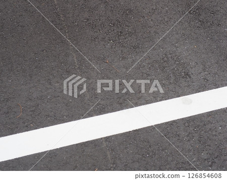A scene from a parking lot. Copy space. Search for and feel the world hidden in the asphalt. Enjoy the time on a cloudy day. A scene from a parking lot. Copy space. Search for and feel the world hidden in the asphalt. Enjoy the time on a cloudy day. 126854608