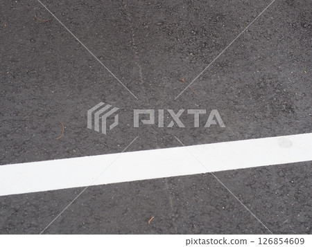 A scene from a parking lot. Copy space. Search for and feel the world hidden in the asphalt. Enjoy the time on a cloudy day. A scene from a parking lot. Copy space. Search for and feel the world hidden in the asphalt. Enjoy the time on a cloudy day. 126854609