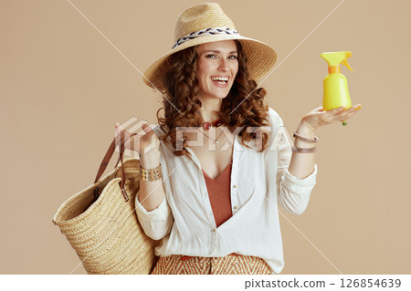 happy modern woman in white blouse and shorts isolated on beige 126854639