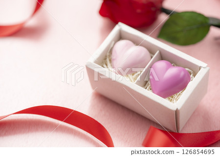 Heart chocolate in a gift box with roses, ribbon and copy space Heart chocolate in a gift box with roses, ribbon and copy space 126854695