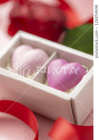 Close-up of heart chocolate with roses and ribbon in gift box Close-up of heart chocolate with roses and ribbon in gift box 126854696