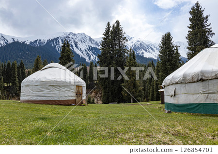 Dwelling of nomads in the mountains. Two yurts Dwelling of nomads in the mountains. Two yurts 126854701