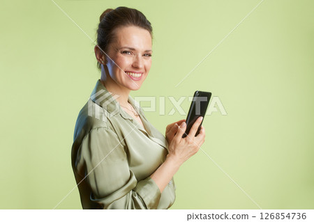 Smiling woman holding smartphone 126854736