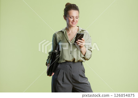 Checking in: Woman on phone with briefcase Checking in: Woman on phone with briefcase 126854875
