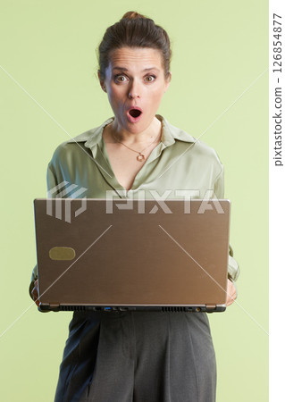 Shocked woman stares at laptop, mouth open 126854877