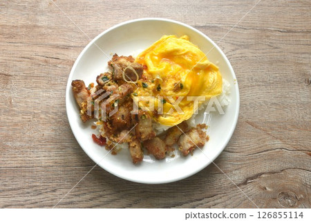 fried spicy crispy pork with chili and garlic topping plain rice dressing creamy egg omelette on plate 126855114