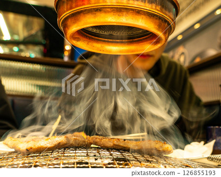 Pork belly with smoke over a charcoal grill 126855193
