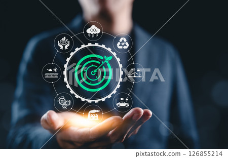 Green Energy and Sustainable Development Target Concept. A person presents green target surrounded by eco-friendly and sustainable development icons, symbolizing environmental and energy goals. 126855214