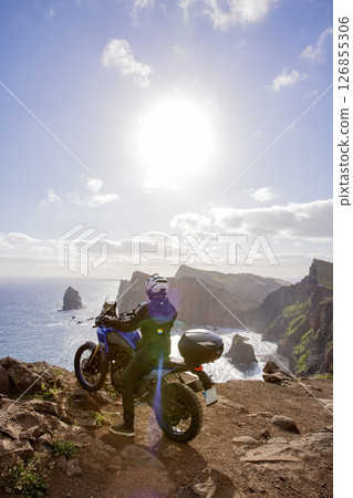 Enduro Motorcycle with Driver Posing on Sea Cliff , Madeira island Enduro Motorcycle with Driver Posing on Sea Cliff , Madeira island 126855306