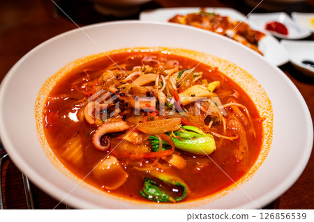 Jjamppong is a Korean noodle soup with red, spicy seafood 126856539