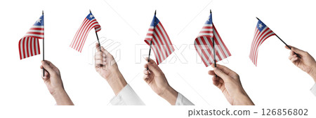 The Liberia flag in hand in different angles on a white background 126856802