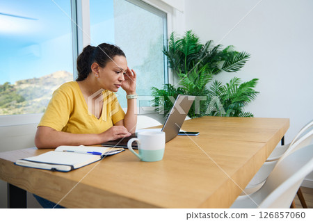 Focused Woman Working from Home on Laptop in Bright Office 126857060