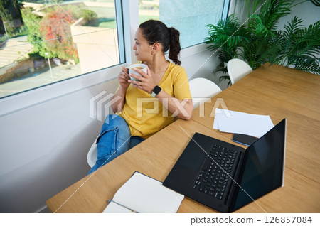 Woman Working Remotely in Home Office Taking a Relaxing Coffee Break 126857084