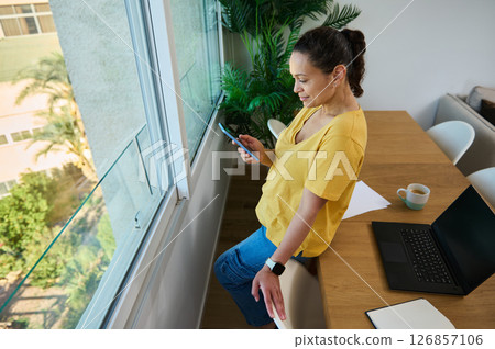 Woman Working From Home Using Smartphone During Break 126857106