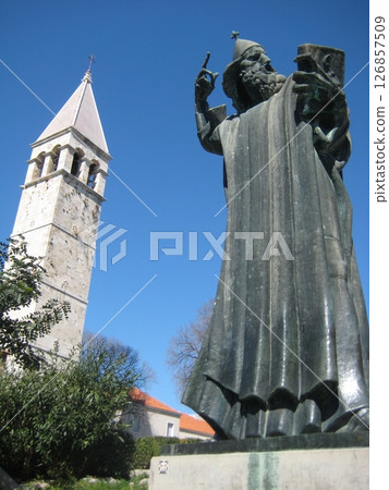 Bell tower and Grgur Ninski statue under blue sky Bell tower and Grgur Ninski statue under blue sky 126857509