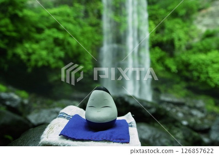 Image of the Okiagari Koboshi (little doll) performing ascetic practices at a waterfall Image of the Okiagari Koboshi (little doll) performing ascetic practices at a waterfall 126857622