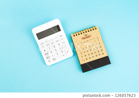 August 2025 brown caculator and white calculator on blue background. August 2025 brown caculator and white calculator on blue background. 126857623