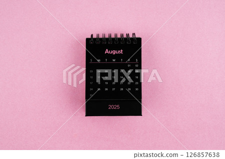 Black calendar for August 2025 year on pink background. 126857638