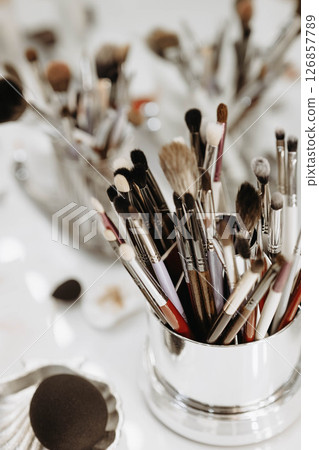 Makeup artist tools glass with brushes. Close-up vertical 126857789