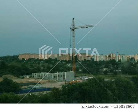 Construction in the city. Infill development in the city. Construction crane for the construction of a residential building 126858603