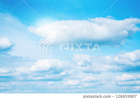Bright blue sky with white clouds and sunlight 126859907