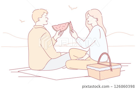 A Couple Enjoying a Cozy Picnic by the Beautiful Beach while Eating Fresh Watermelon Pieces 126860398