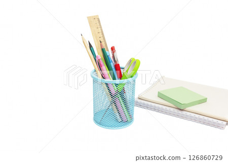 School and office supplies, pens, pencils, ruler, compass in a metal cup on a white background. 126860729