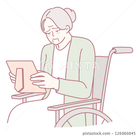 An Elderly Woman in a Wheelchair is Gently Reading a Letter with deep emotional reflection 126860845