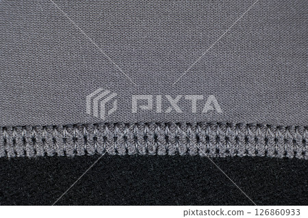 Macro texture of gray fabric consisting of cotton with a slight addition of elastane. Stitching with threads 126860933