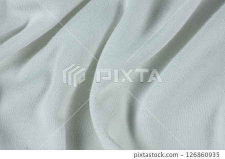 Macro texture of a fabric consisting of one hundred percent cotton. Macro texture of a fabric consisting of one hundred percent cotton. 126860935