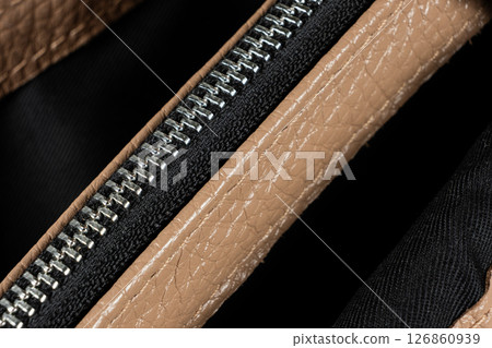 Metal zipper on the inside pocket of the leather bag. Metal zipper on the inside pocket of the leather bag. 126860939