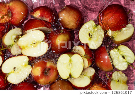 Juicy Whole and Cut Red Apples Close-Up in Water Splash Top View Juicy Whole and Cut Red Apples Close-Up in Water Splash Top View 126861017