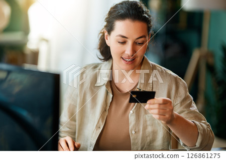 Woman is doing online purchases Woman is doing online purchases 126861275