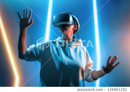 Woman with VR virtual reality goggles 126861282
