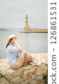 Tourist enjoying view of chania lighthouse in crete, greece 126861531