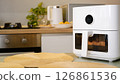 White air fryer cooking food in modern kitchen 126861536