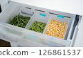 Frozen vegetables preserving freshness in refrigerator drawer: peas, green beans, and corn 126861537