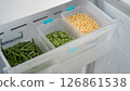 Frozen vegetables preserving freshness in refrigerator drawer: peas, corn, and green beans 126861538