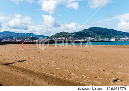 Beautiful beach landscape in Getxo, Spain, featuring mountains, clear sky, and soft sand. Beautiful beach landscape in Getxo, Spain, featuring mountains, clear sky, and soft sand. 126861779