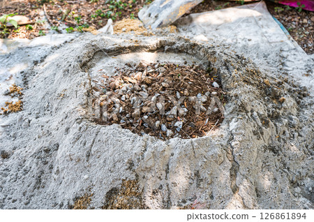 Manual concrete mixing with sand, cement and water, using shovel and trowel on outdoors 126861894