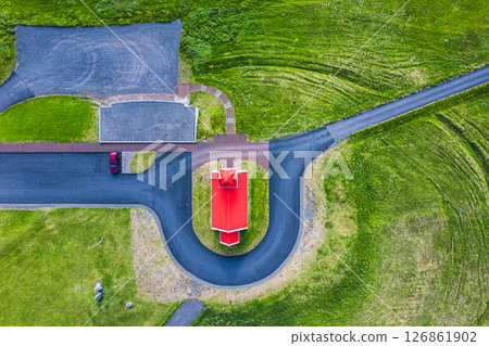 Holy Ingjaldsholskirkja or Ingjaldsholl Church among lush hill in summer at Iceland Holy Ingjaldsholskirkja or Ingjaldsholl Church among lush hill in summer at Iceland 126861902
