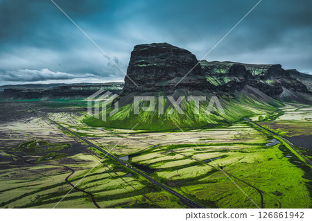 Moody rugged volcanic Lomagnupur mountain and highway over wilderness in summer at Iceland 126861942
