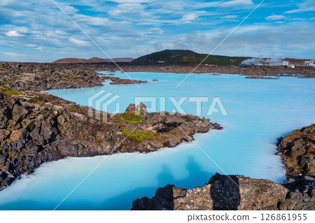 Blue lagoon amidst rocky terrain in natural lava field, Geothermal spa naturalism 126861955