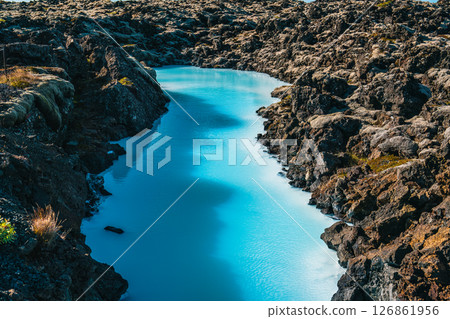 Tranquil Blue Water Amidst Rocky Terrain in Natural Landscape 126861956
