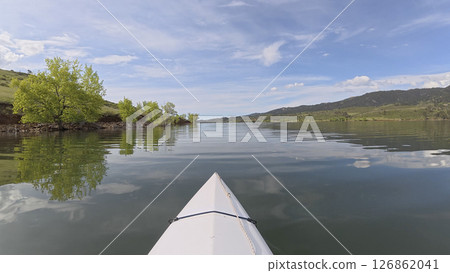 spring kayaking or canoeing in a on calm Horsetooth Reservoir near Fort Collins, Colorado - POV paddler perspective spring kayaking or canoeing in a on calm Horsetooth Reservoir near Fort Collins, Colorado - POV paddler perspective 126862041