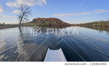 rowing scenery from a calm lake at foothills of Rocky Mountains - rower POV view 126862048